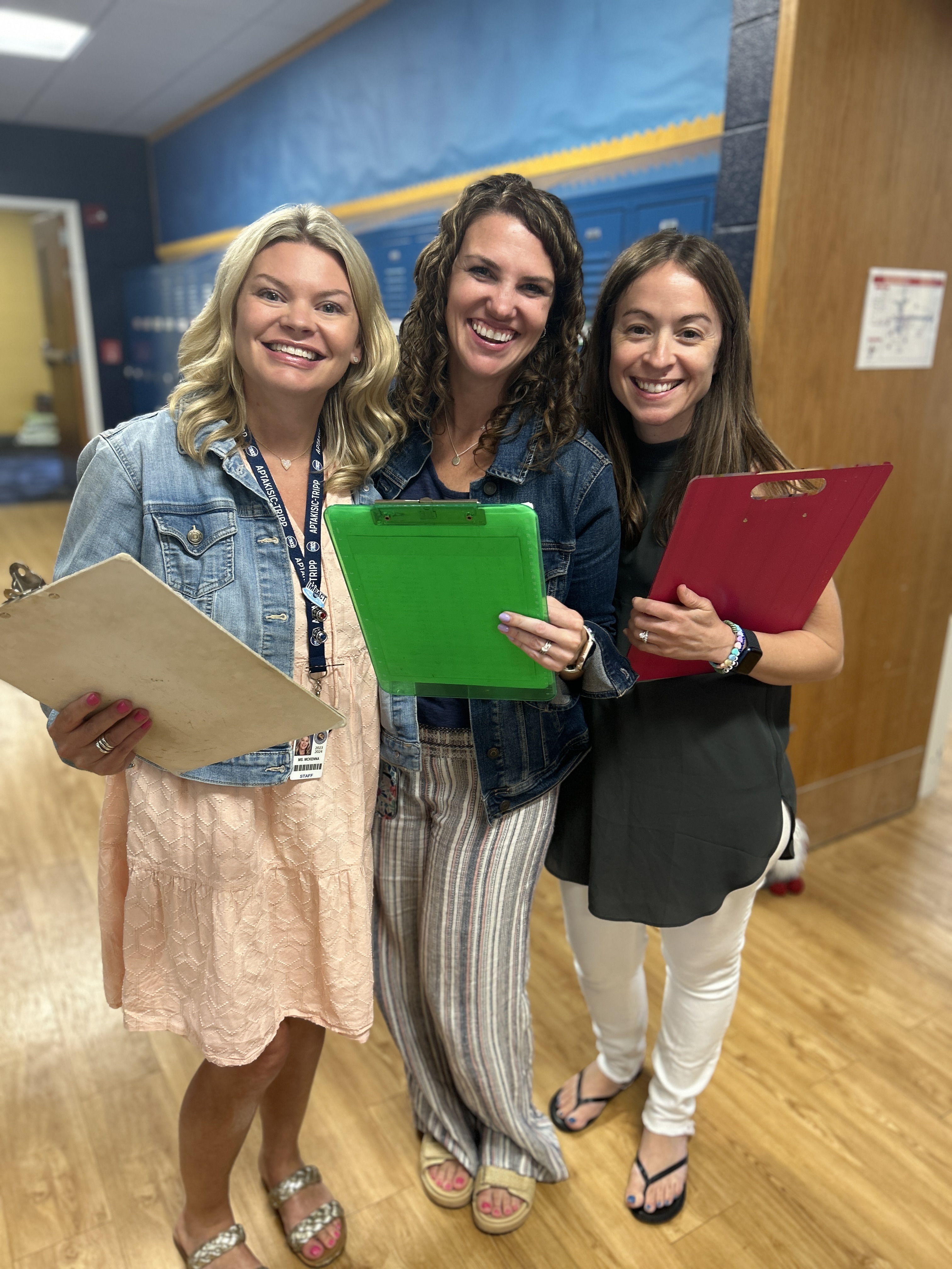 3 teachers holding clipboards.