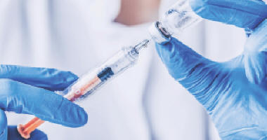 Nurse filling a syringe