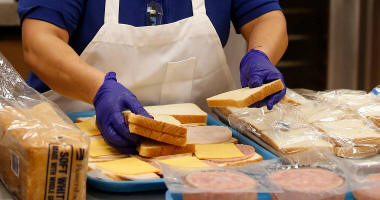 Cafeteria worker making sandwiches
