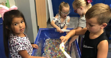 Students playing at a sensory table