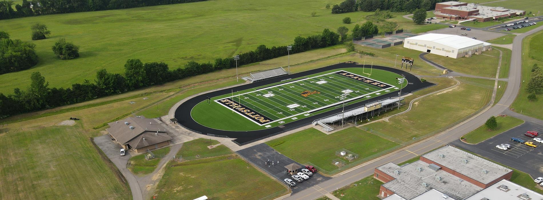 foodball field shot from a drone with the school next to it