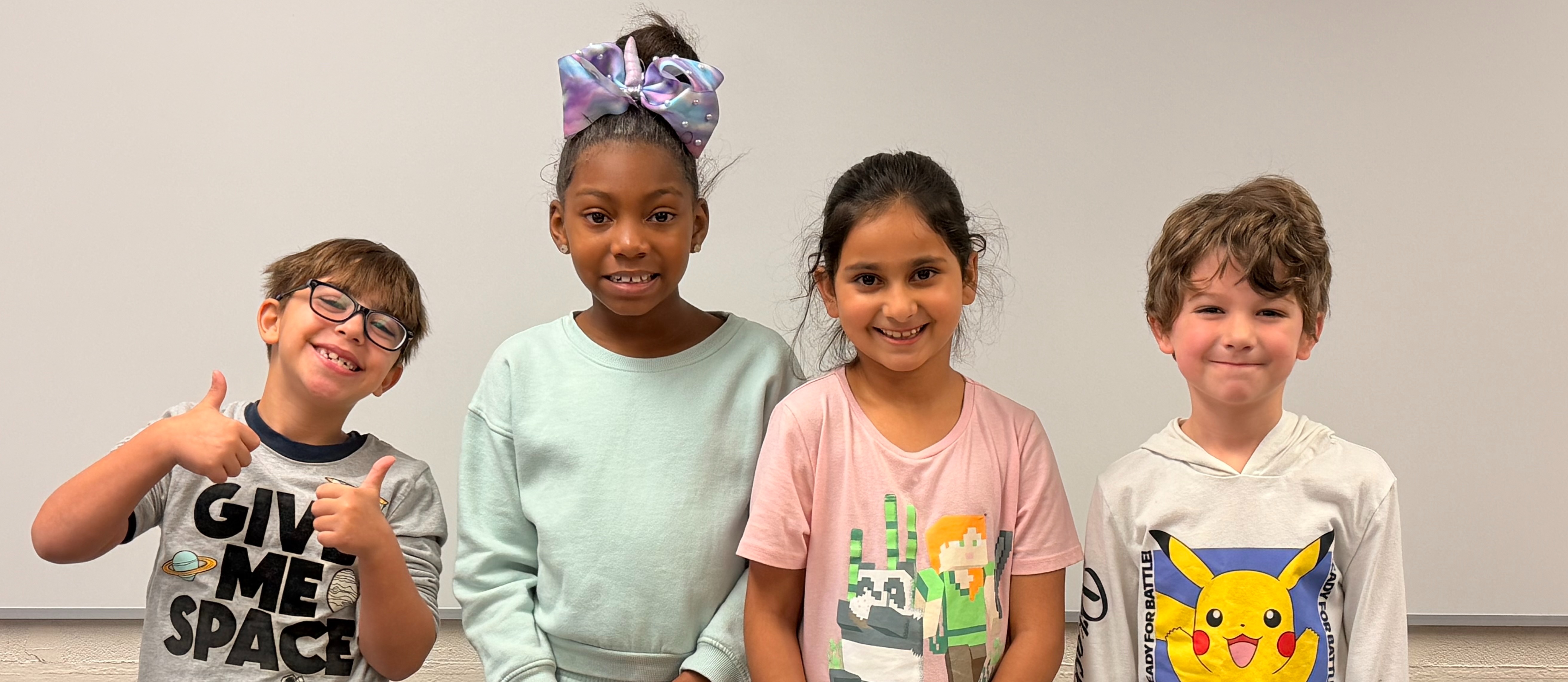 Picture of four students standing together smiling