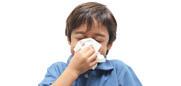 boy sneezing and wiping his nose
