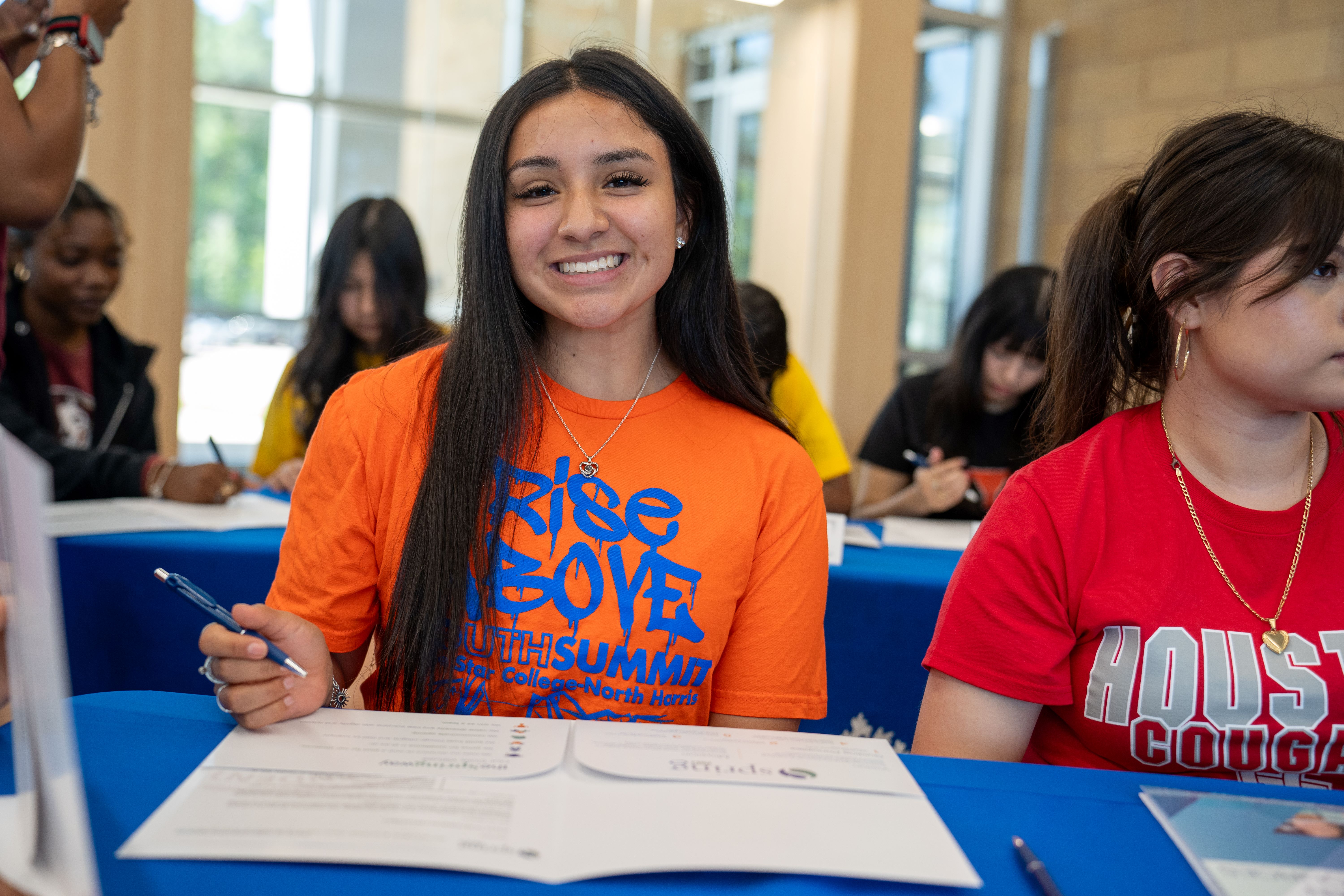 Spring ISD CTE student signing commitment during Future Educator's signing day