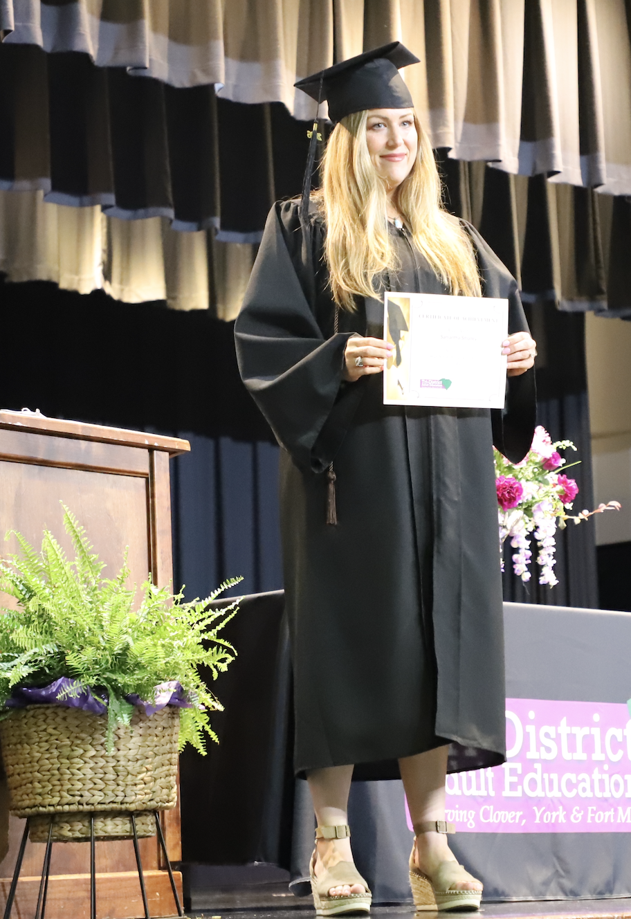 Student holding up diploma