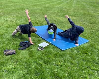 Students doing yoga outside