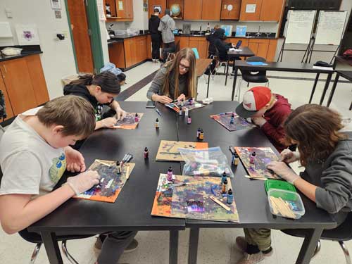 Students in art class working