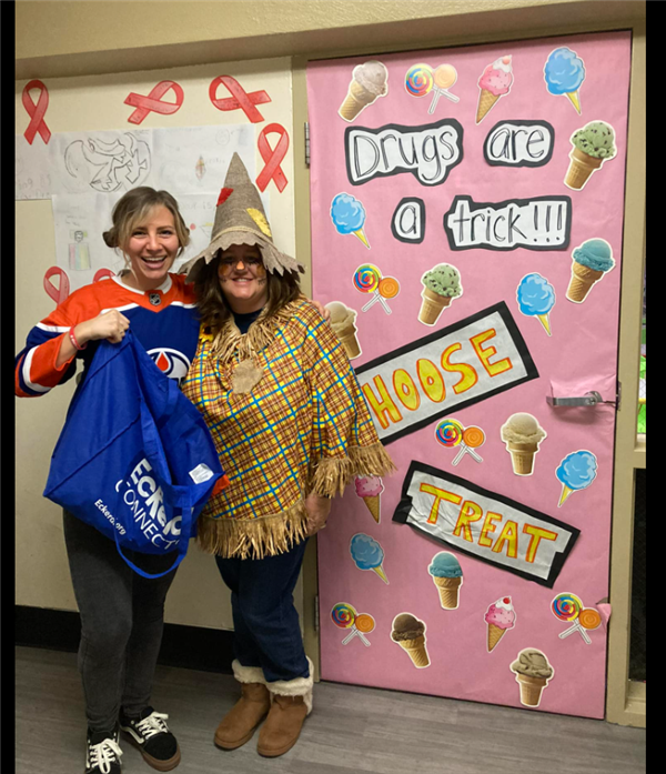 2 teachers standing and dressed with costumes 
