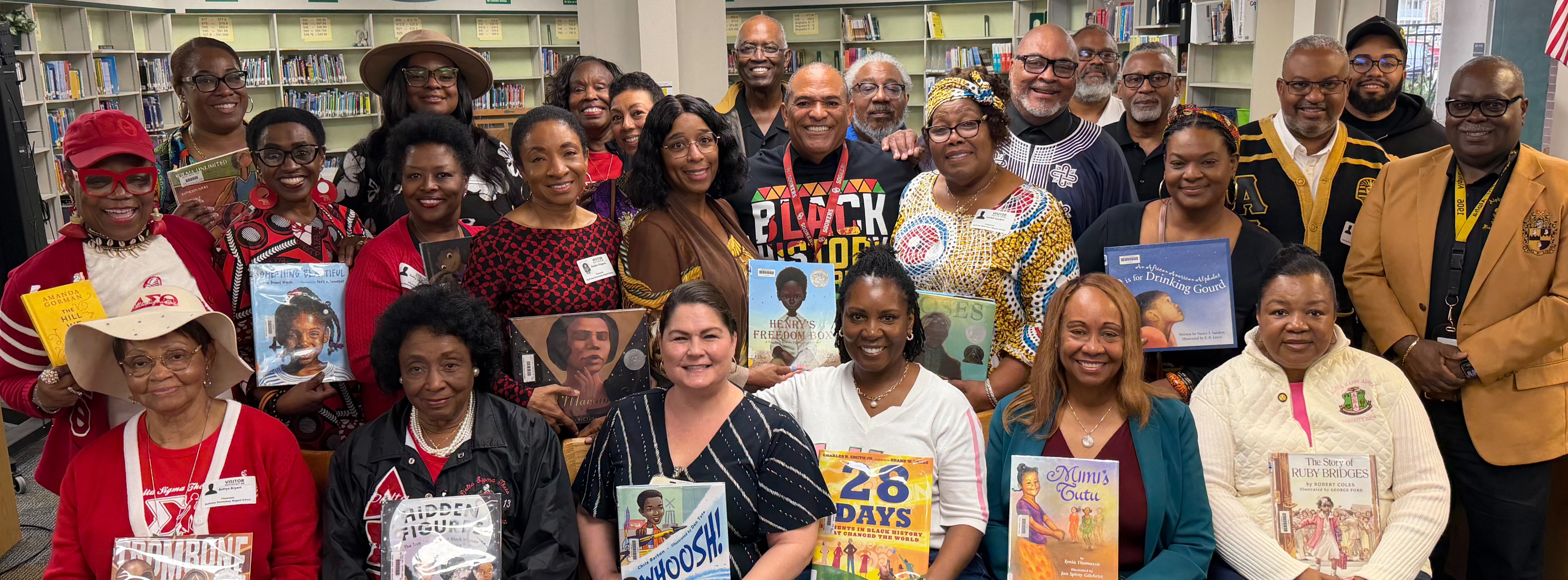 Group of adults holding picture books.