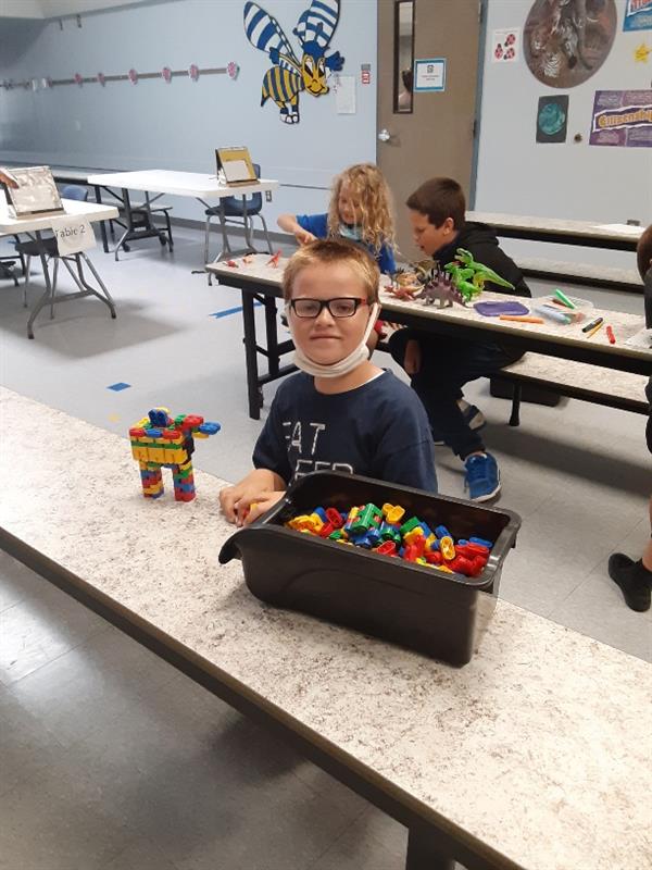 student playing with legos