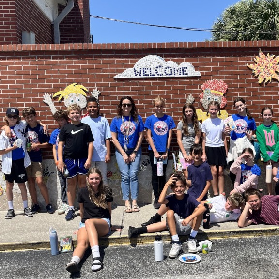 Students on the sidewalk posing for a picture