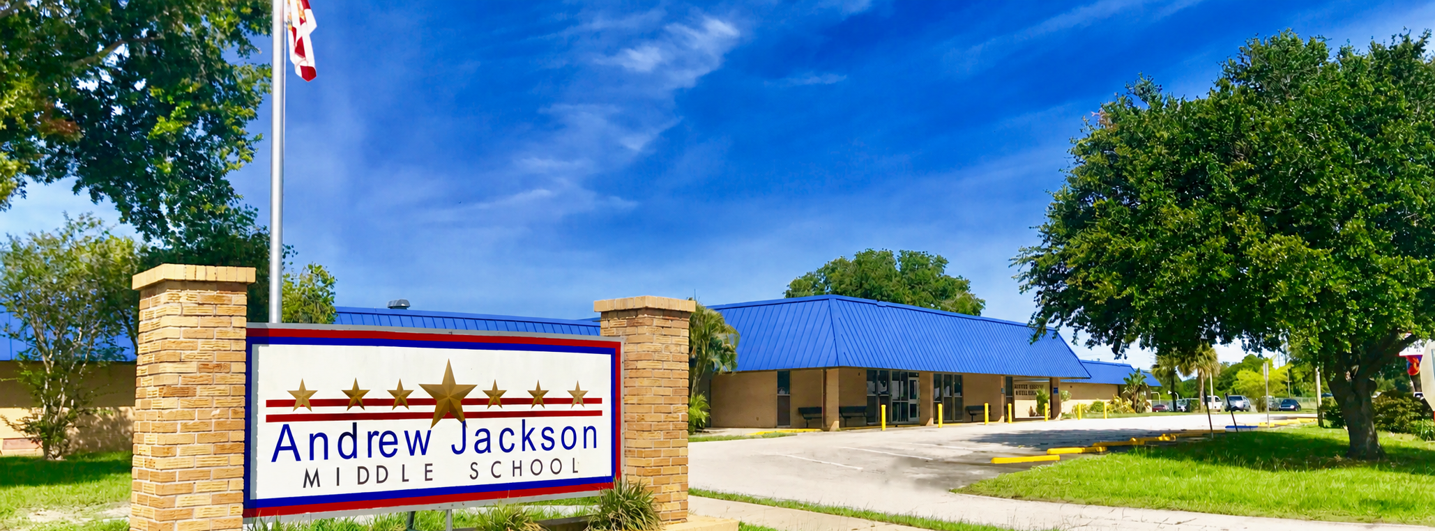 Street view photo of front of school building and Andrew Jackson Middle School sign.