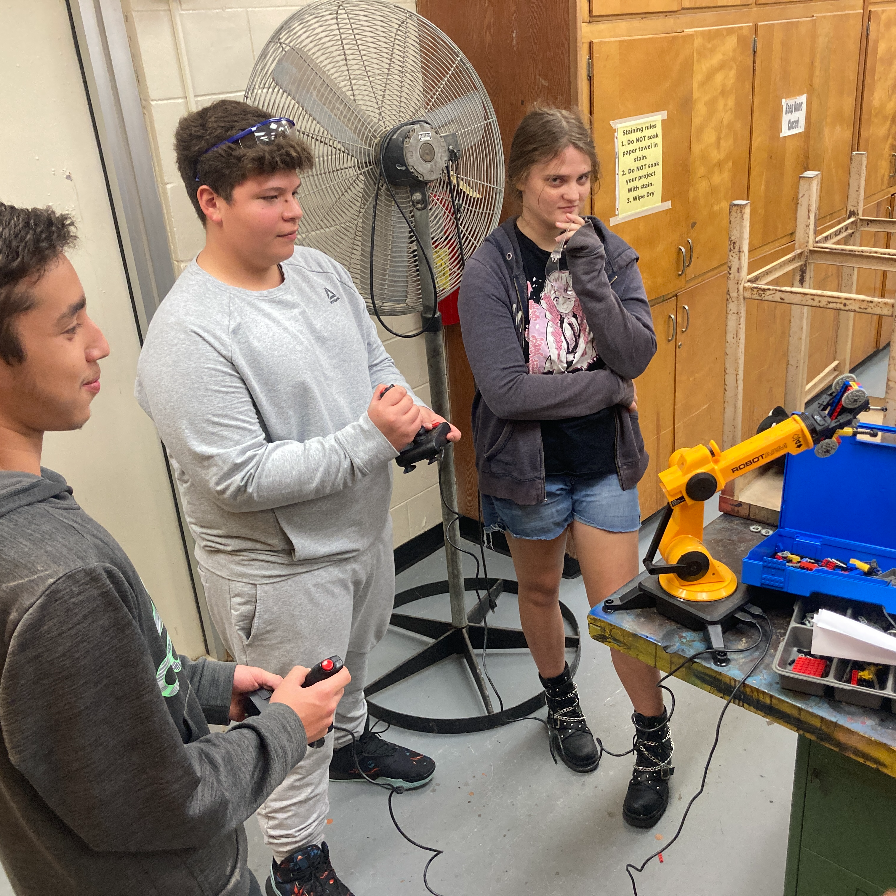 Students piloting a robotic arm
