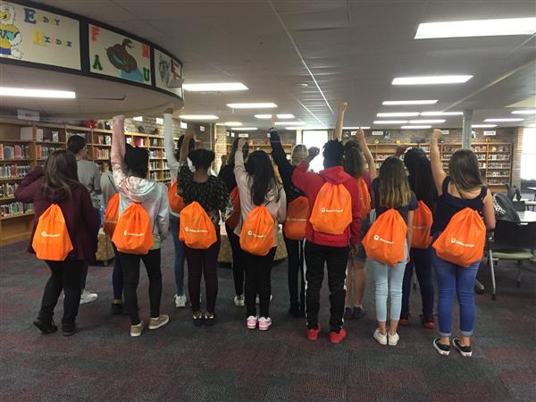 Students with backpacks posing for a picture