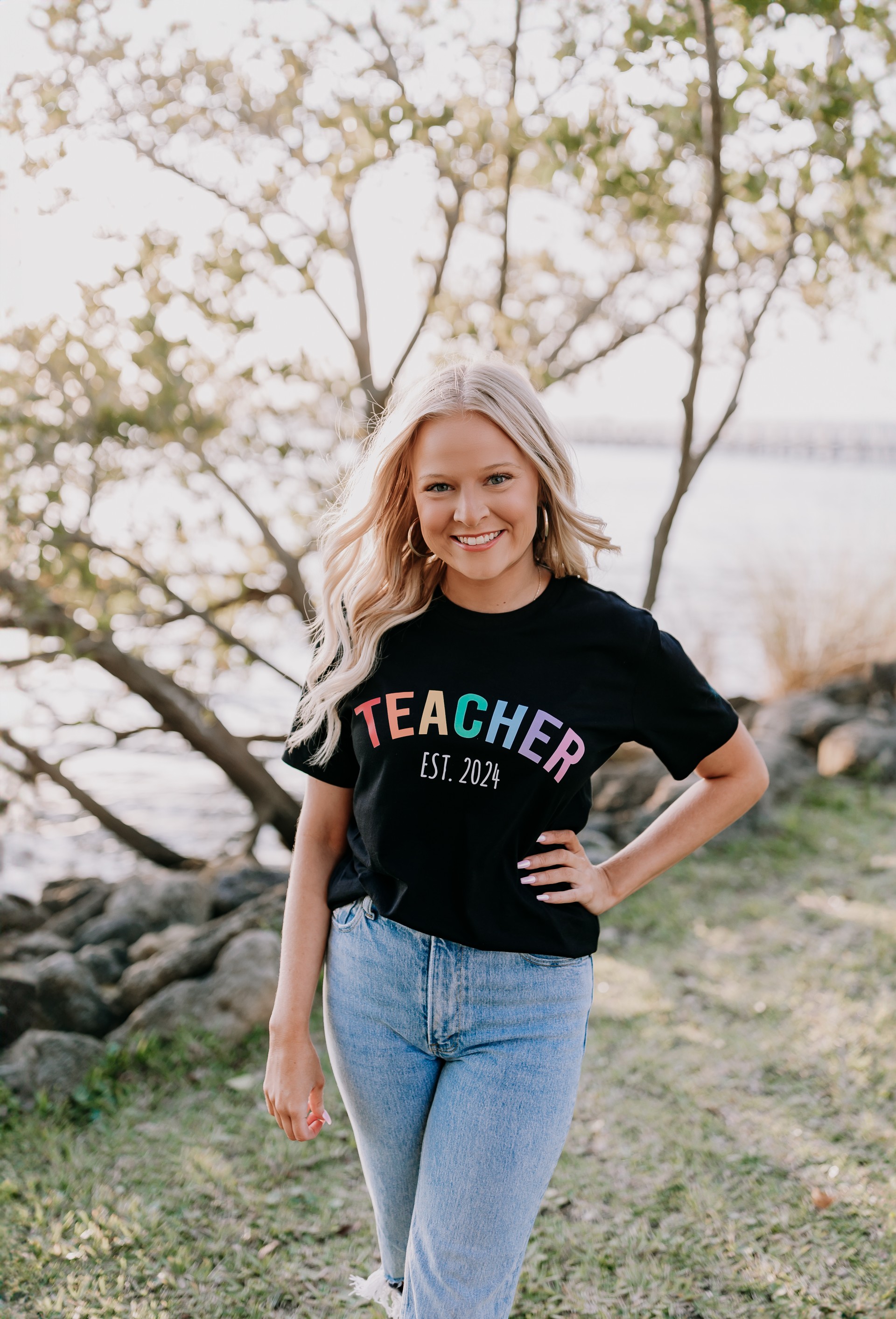 Coach Grace in front of tree near water