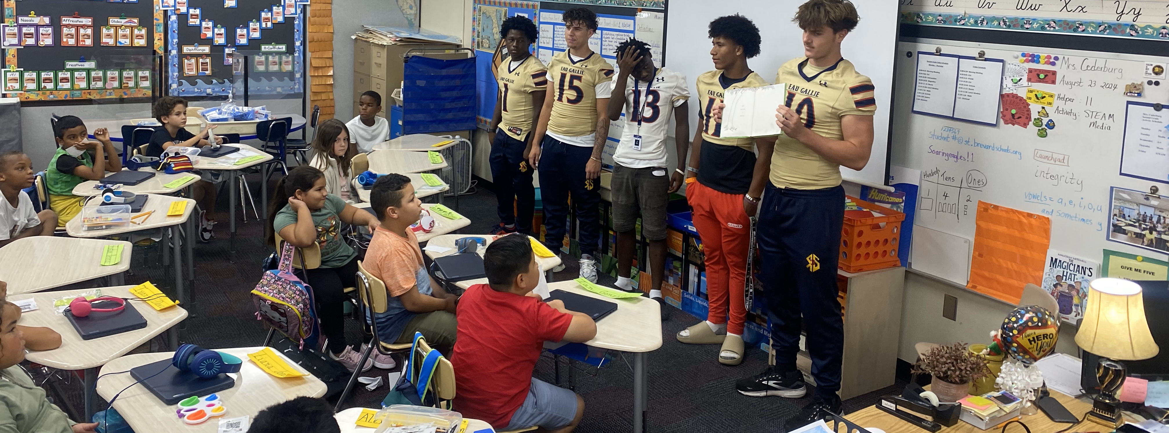 Football players read to Creel elementary