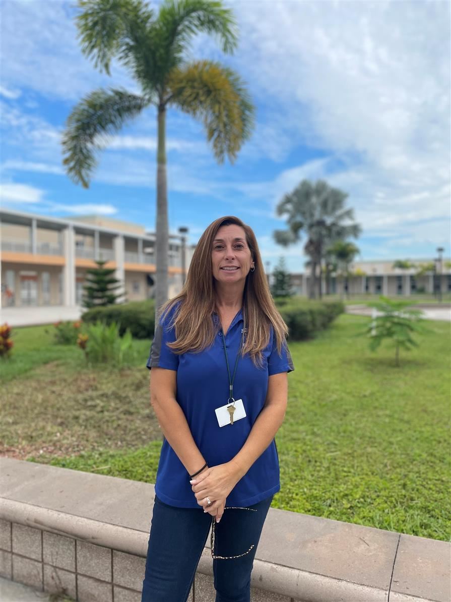 Ms. Maroto in front of a palm tree
