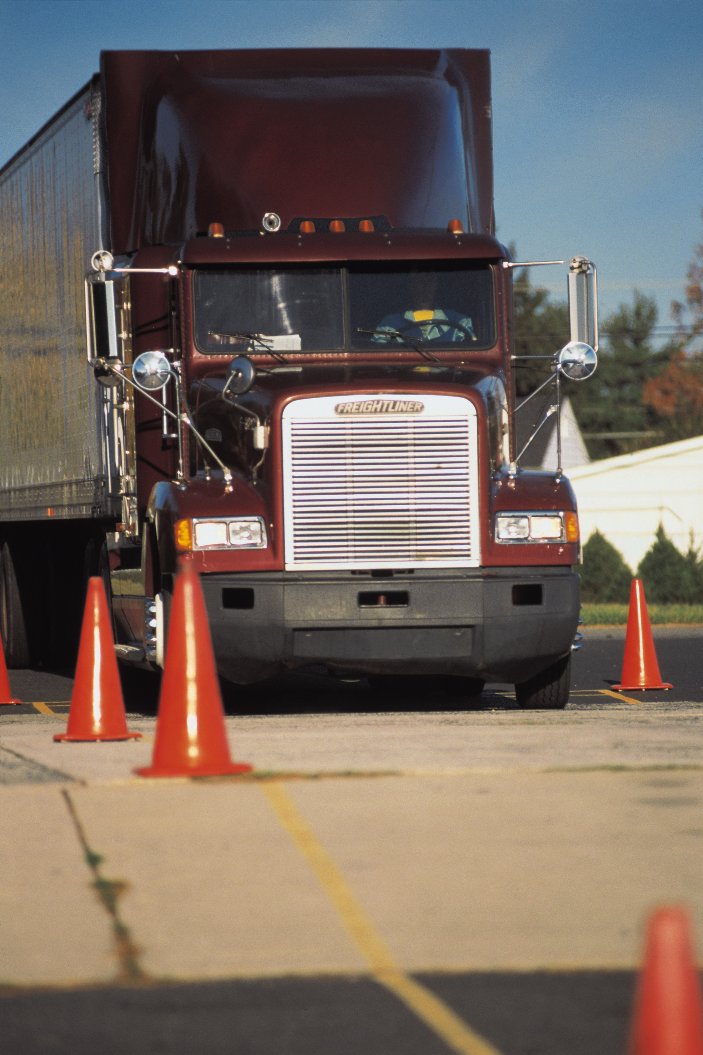 tractor trailer going through orange safety cones