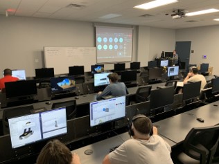 Students in a class with computers recieving instruction on the SolidWorks program