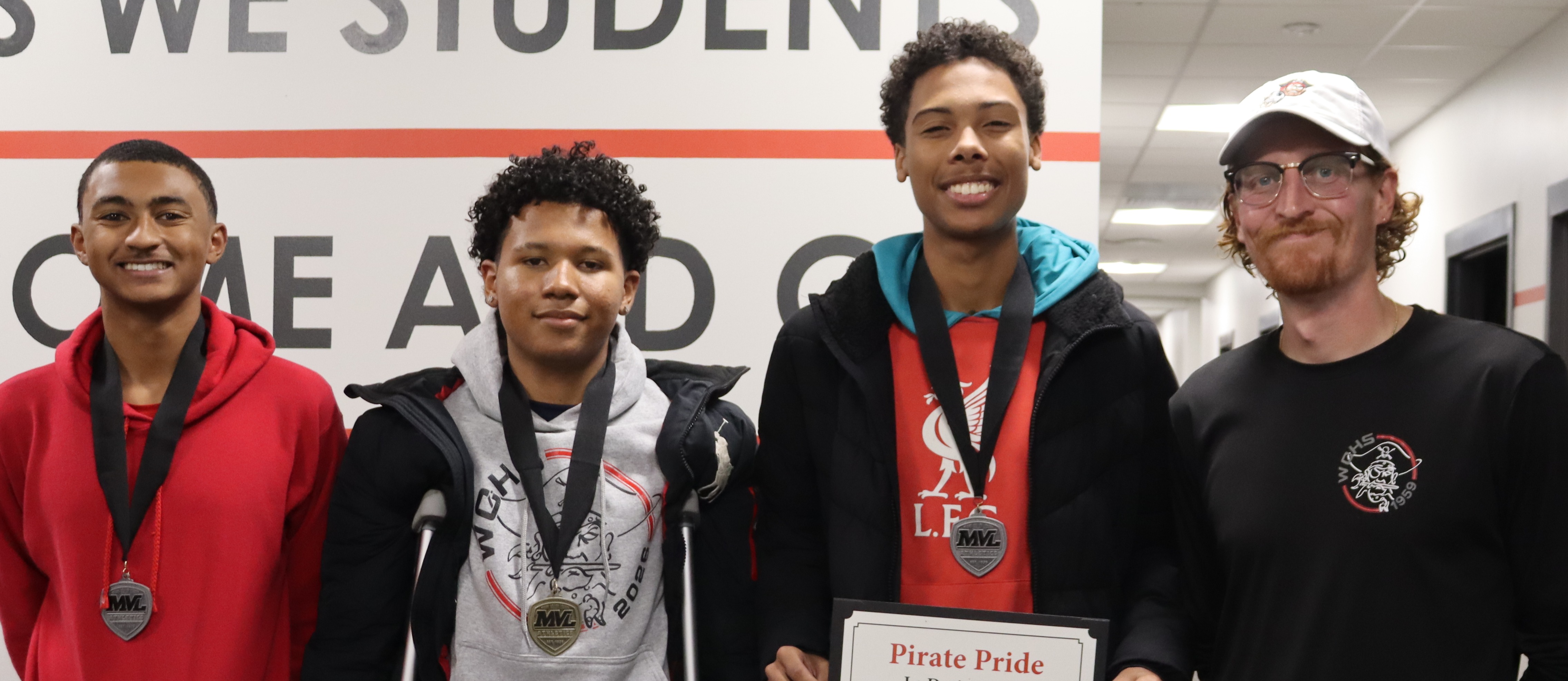 3 soccer players with Coach