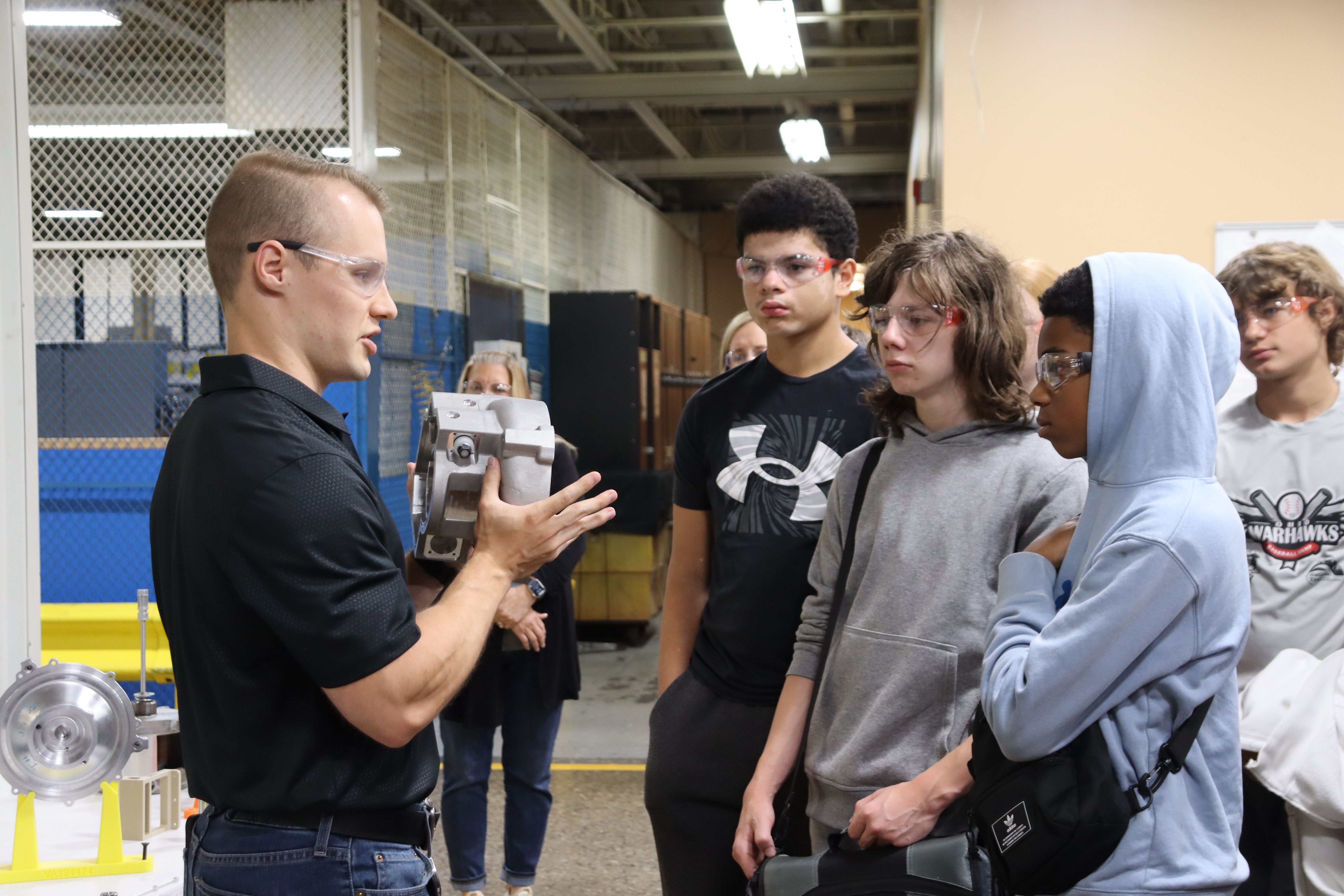 students looking at a part