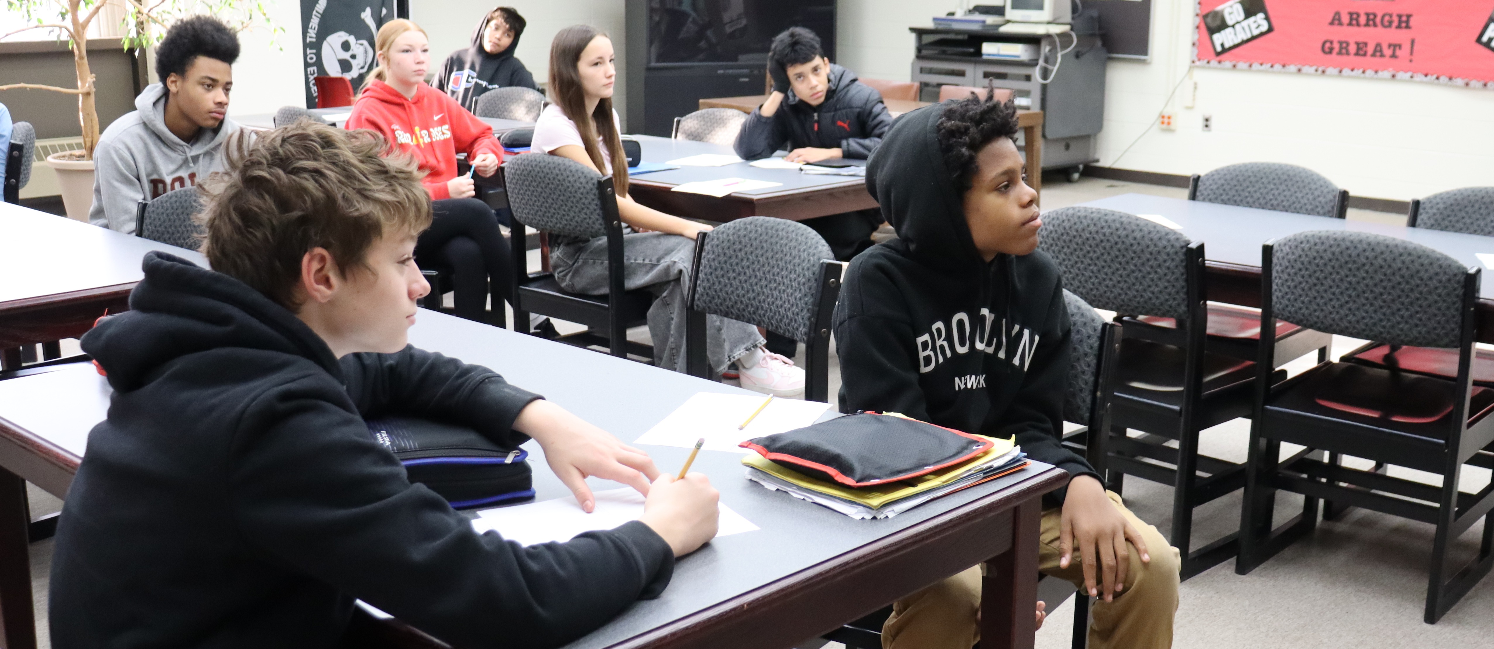 Students at desks listening to presentation