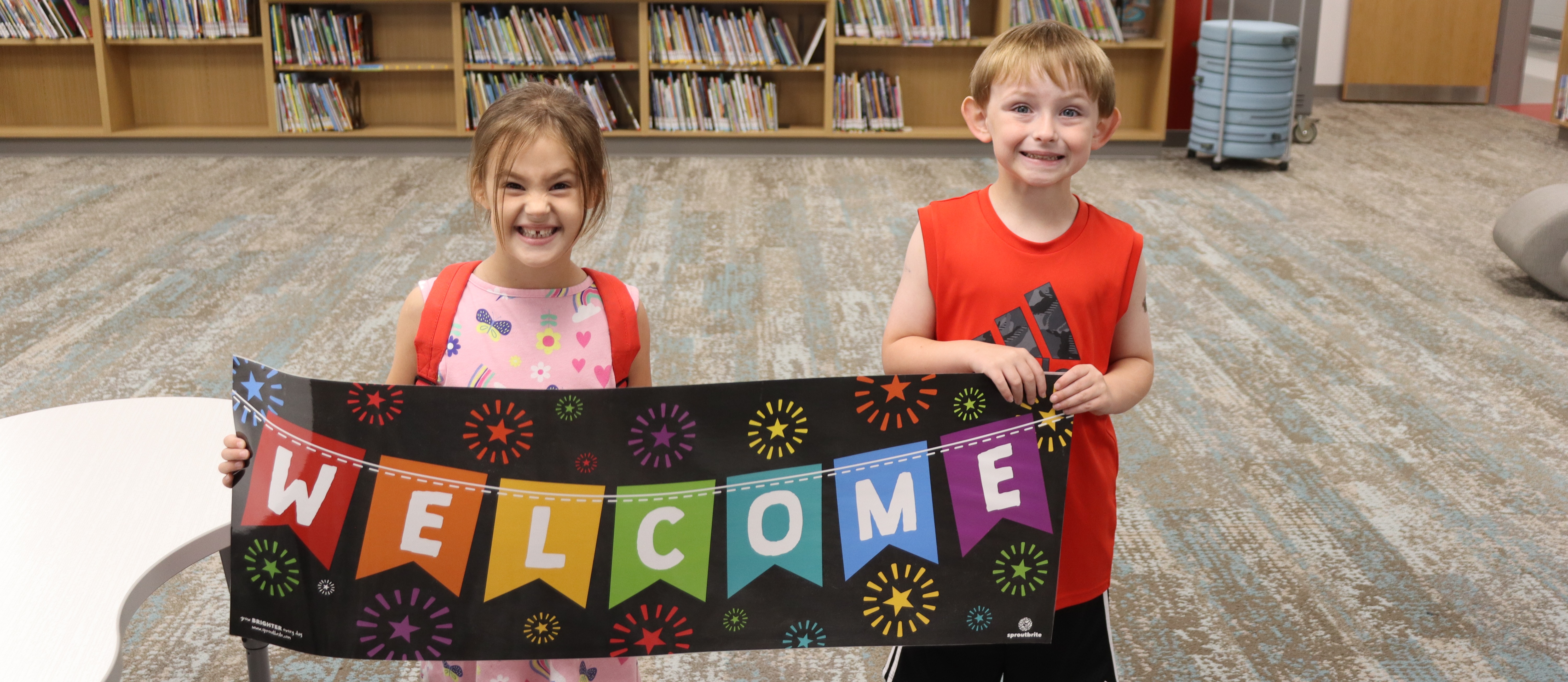 students holding welcome sign