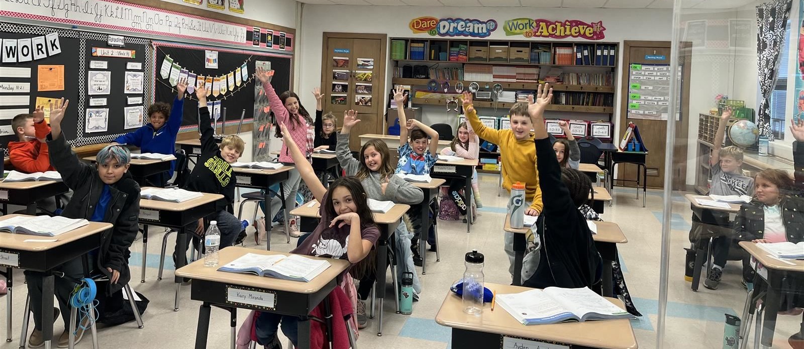 4th grade students raising hands in class