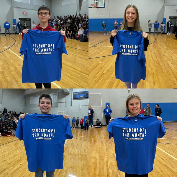 students holding student of the month shirt