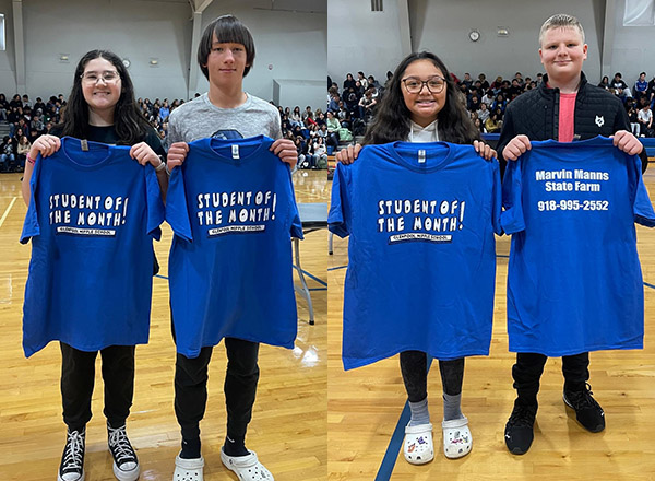 students holding student of the month shirt