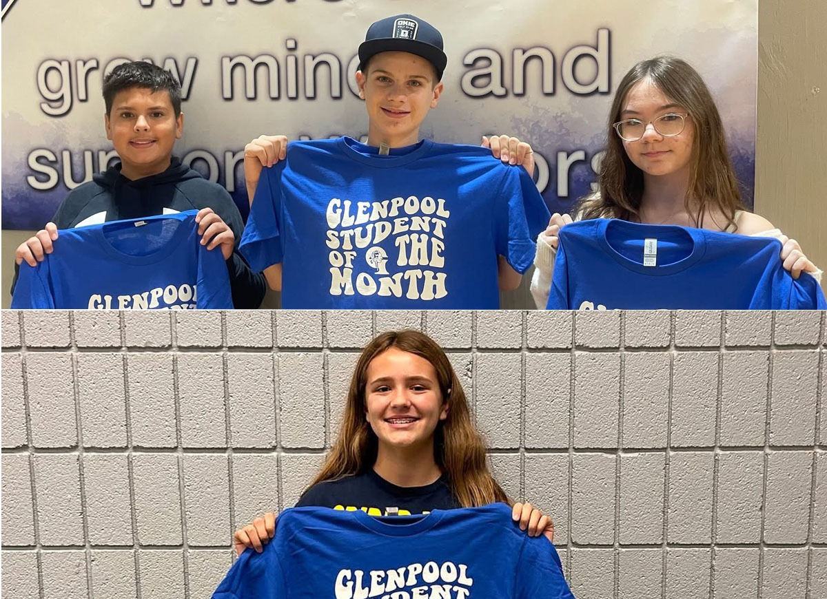 students holding student of the month shirt