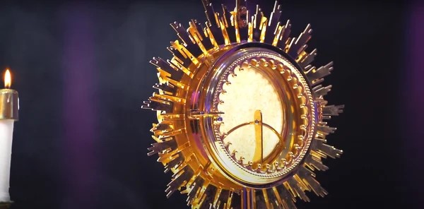 The image shows a close-up of a monstrance. A monstrance is a liturgical object used in the Catholic Church to display the consecrated Eucharist.