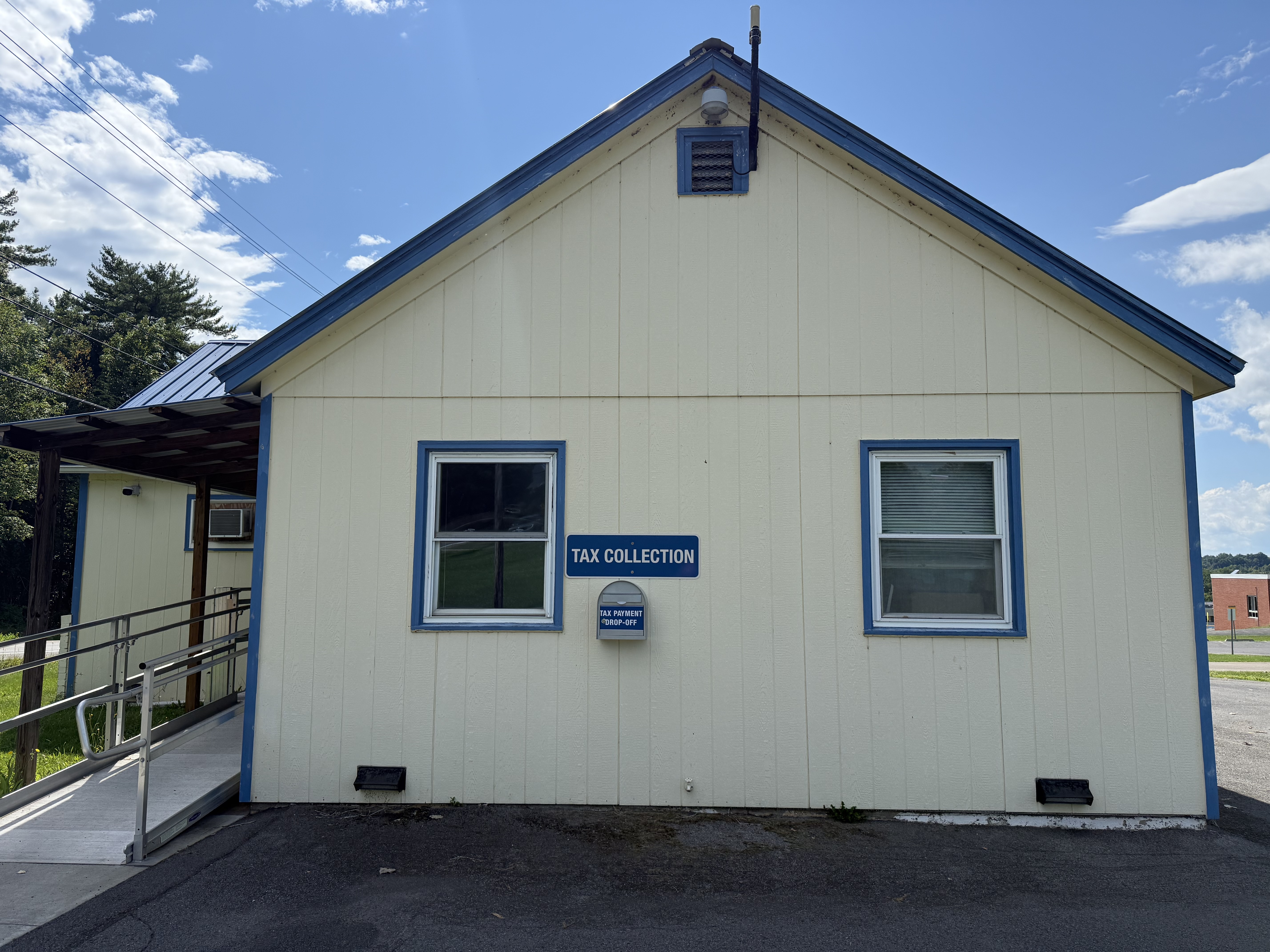 Picture of Yellow Building with Tax Collection Sign