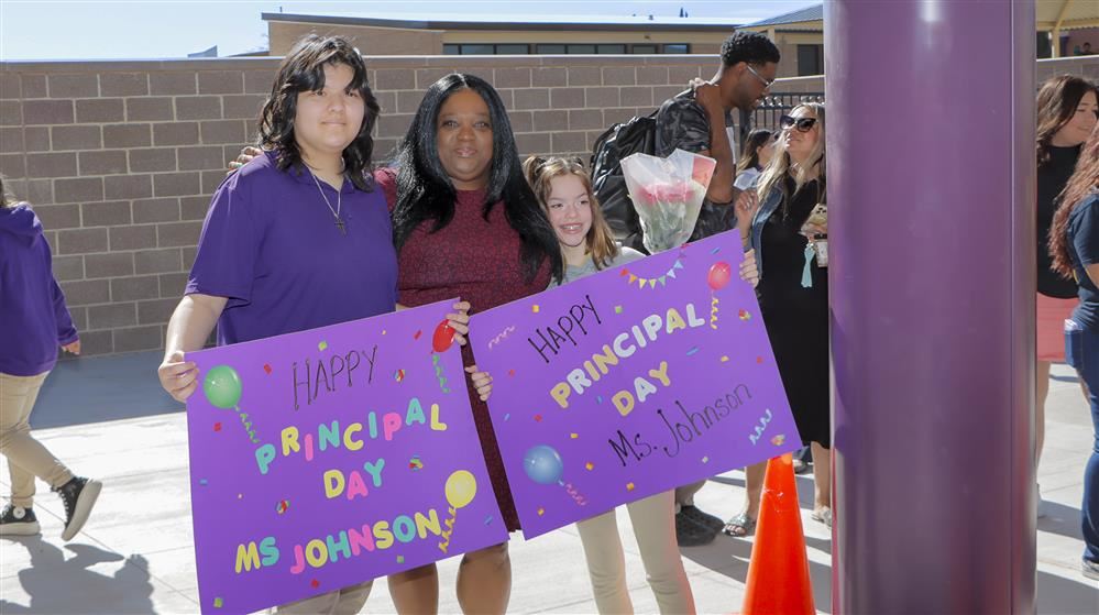 girls holding a sign