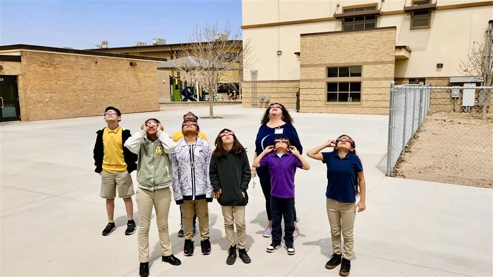 kids staring at the sky wearing snglasses