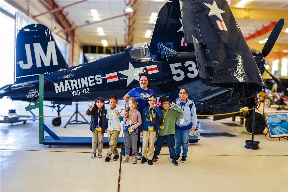 students at the museum smiling