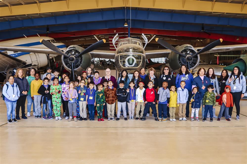 students at the museum smiling