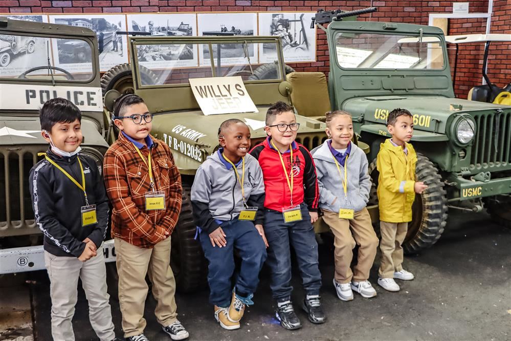 students at the museum smiling