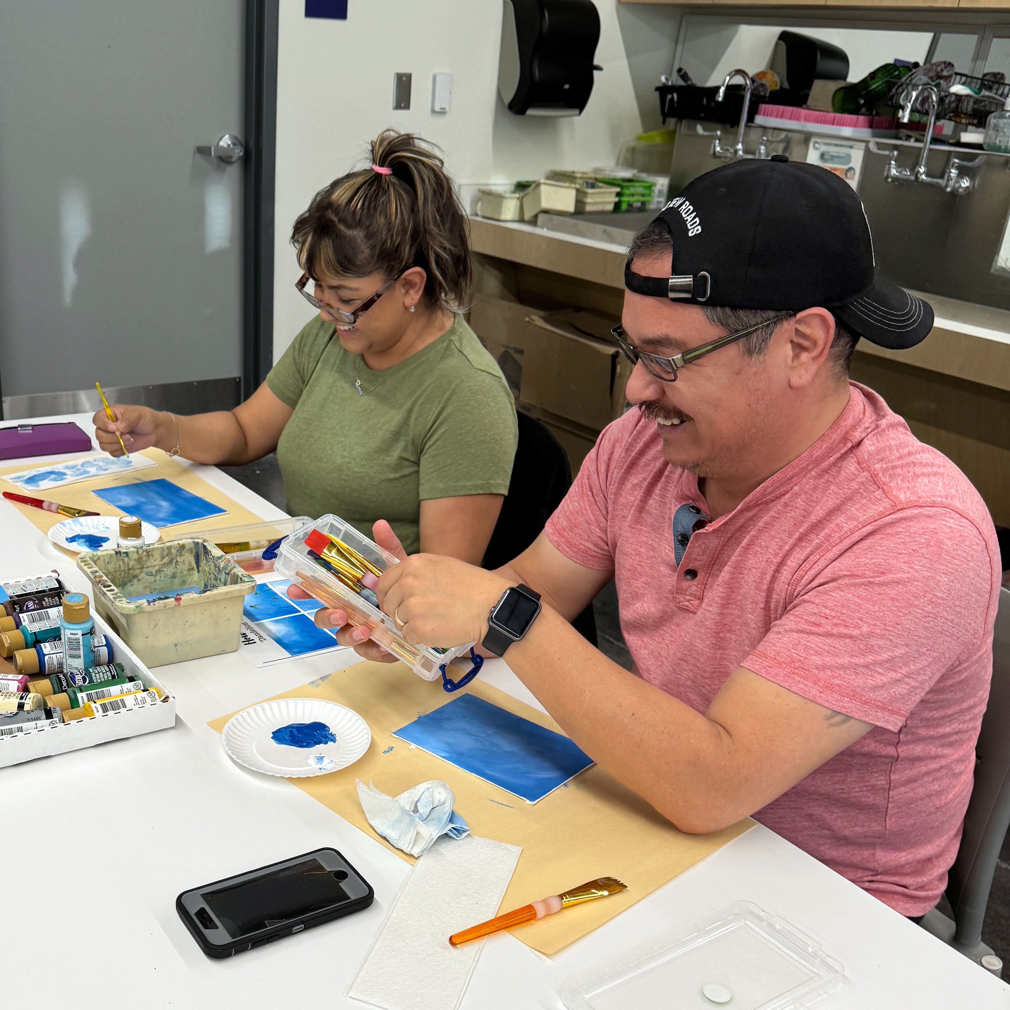 Employees smiling and creating art