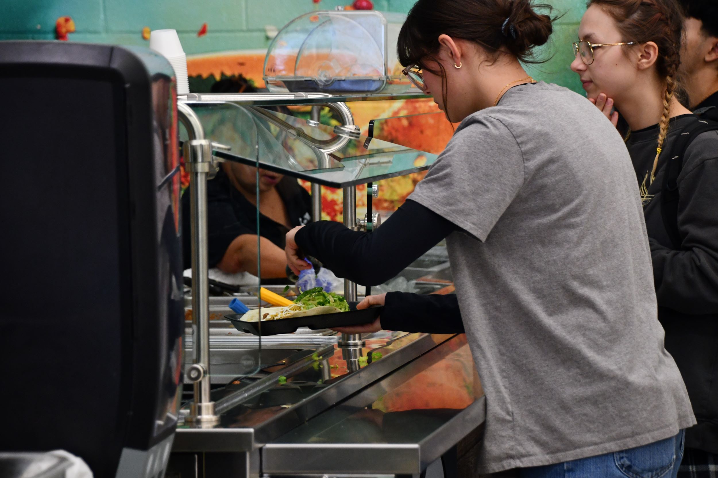 students self serving on the street food station at AHS