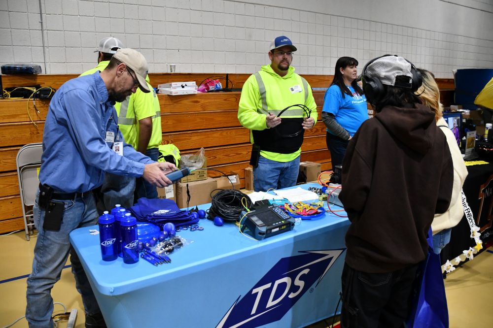 TDS Staff behind a table at career expo