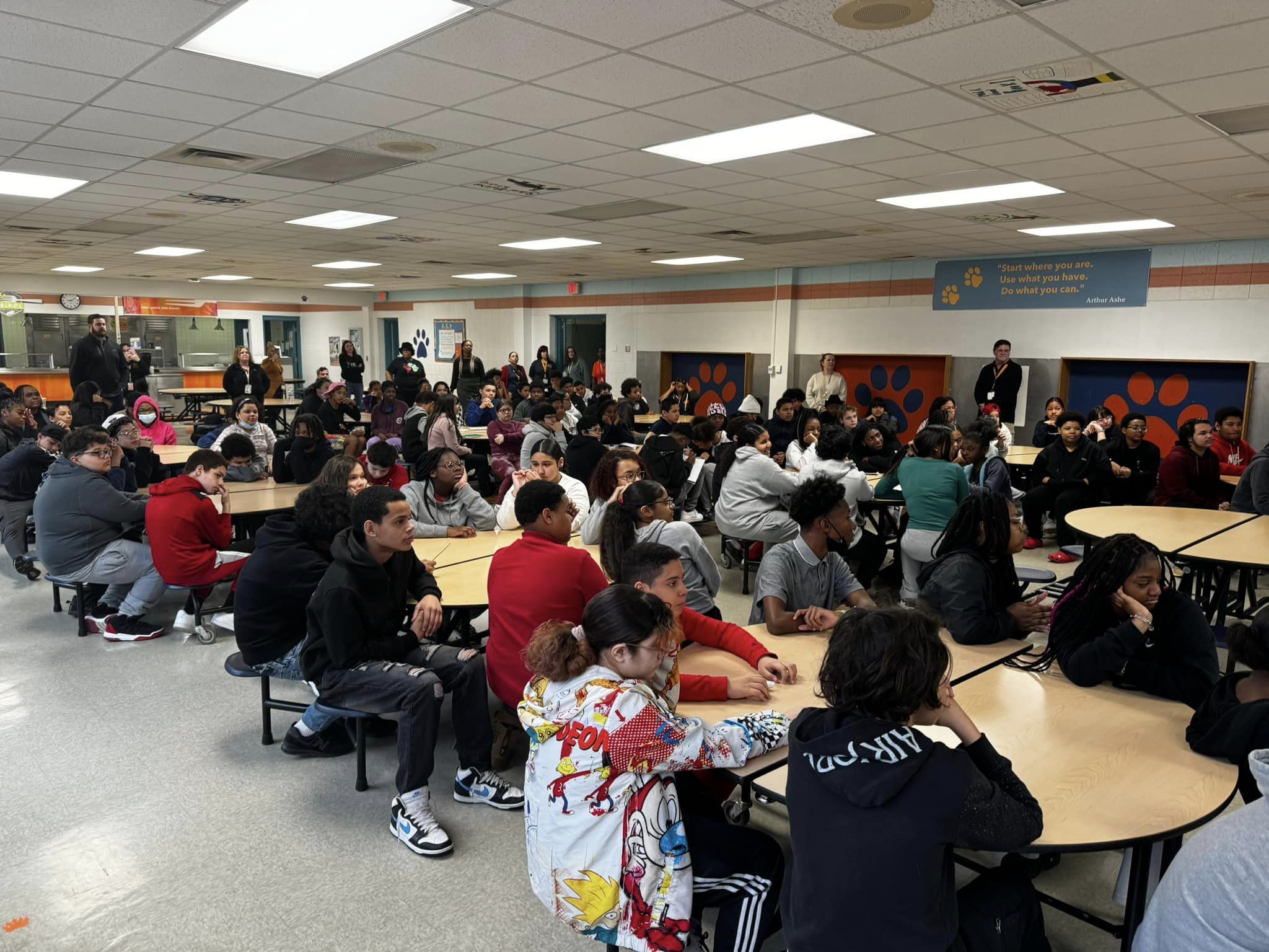 students sitting in cafeteria for a speaker