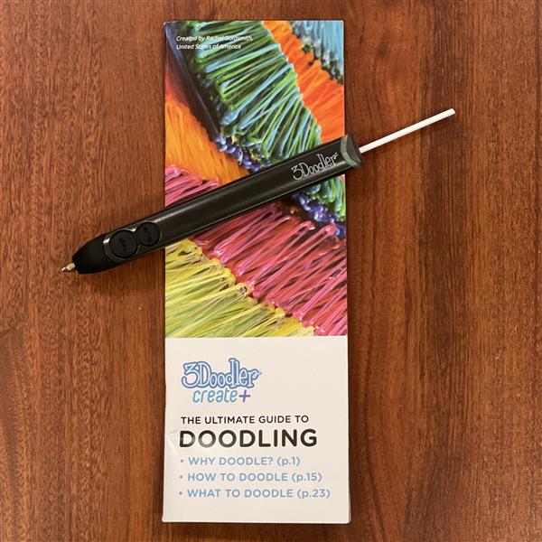 3Doodler pen sitting on top of its box.