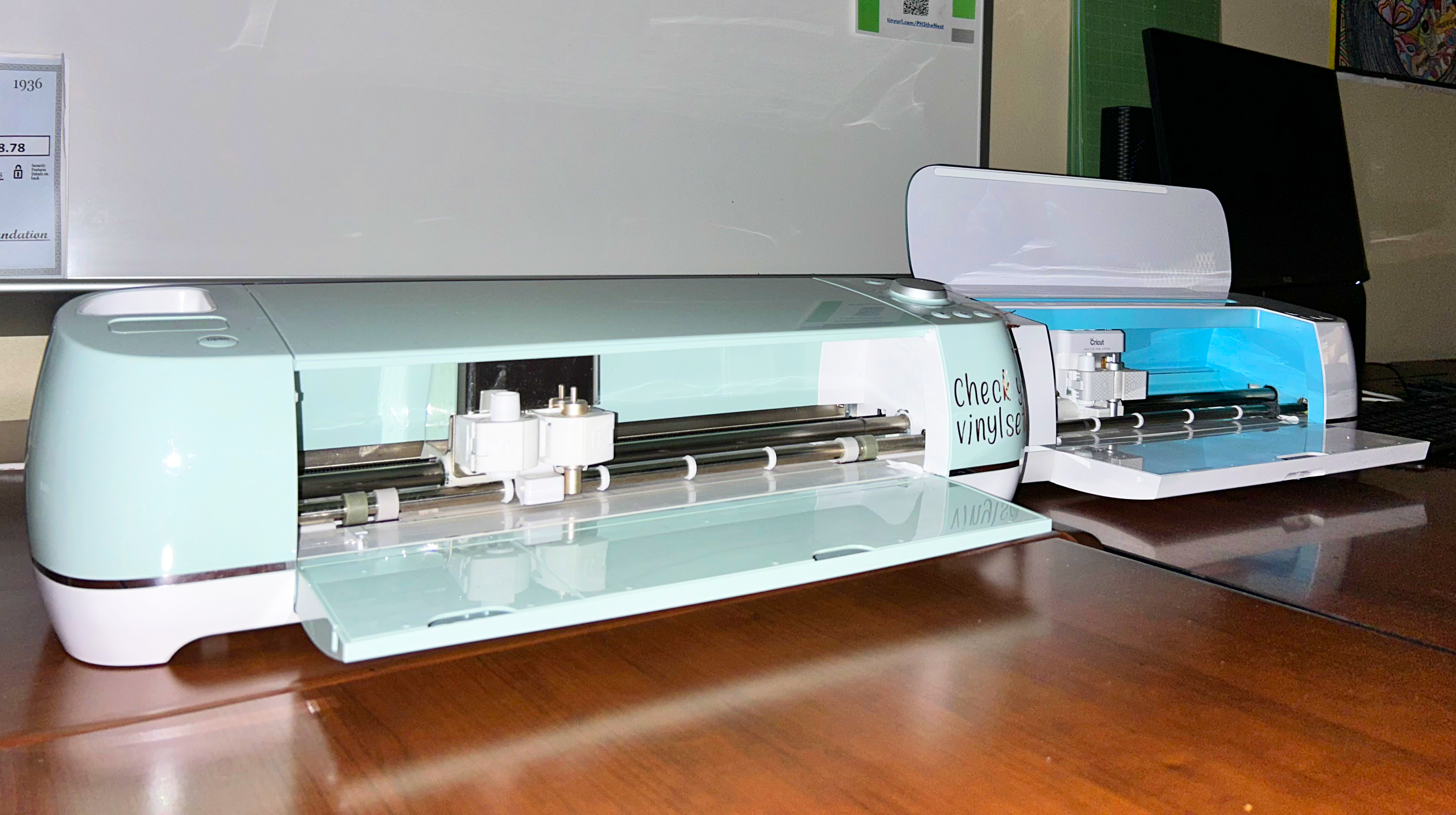 Two Cricut machines sitting on desks