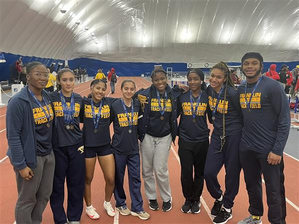 track team poses with medals