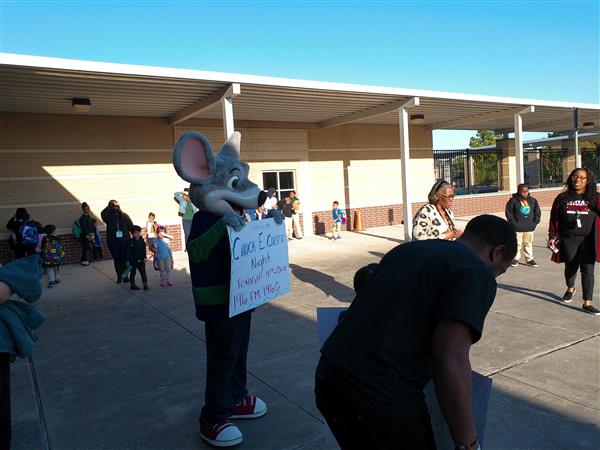  lively scene of a mouse character interacting with people, possibly an event or gathering.