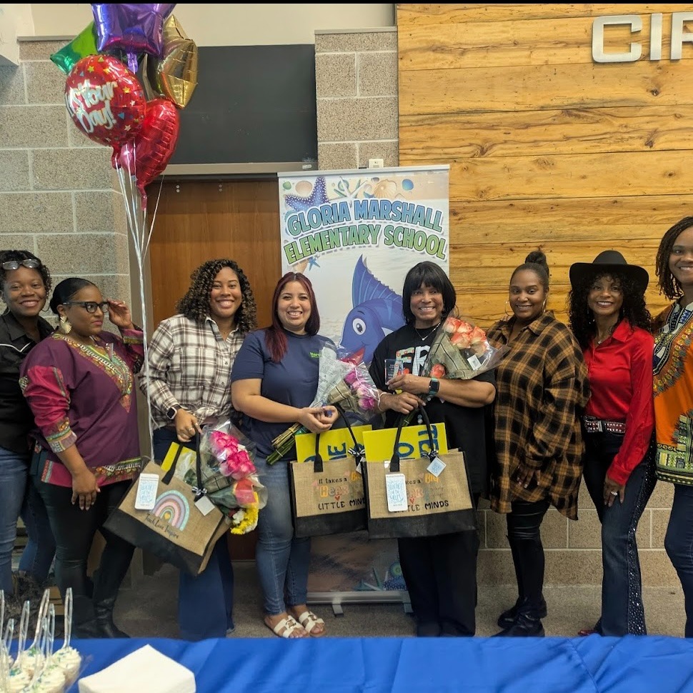 teachers of the year smiling at the camera with flowers