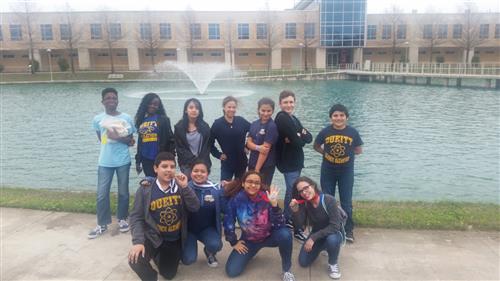 students in front of a fountain posing for a picture