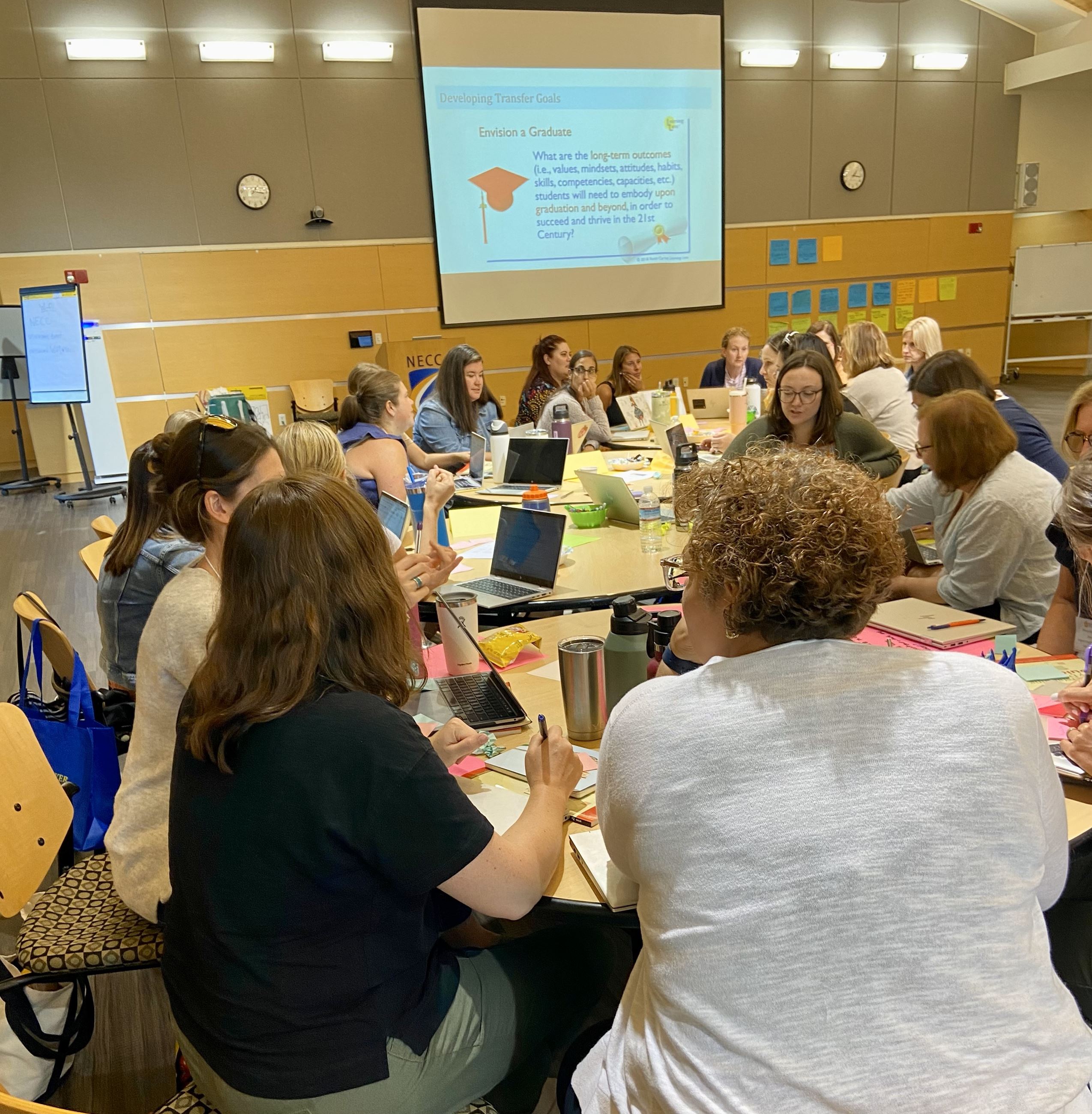 Teachers sitting together discussing and working