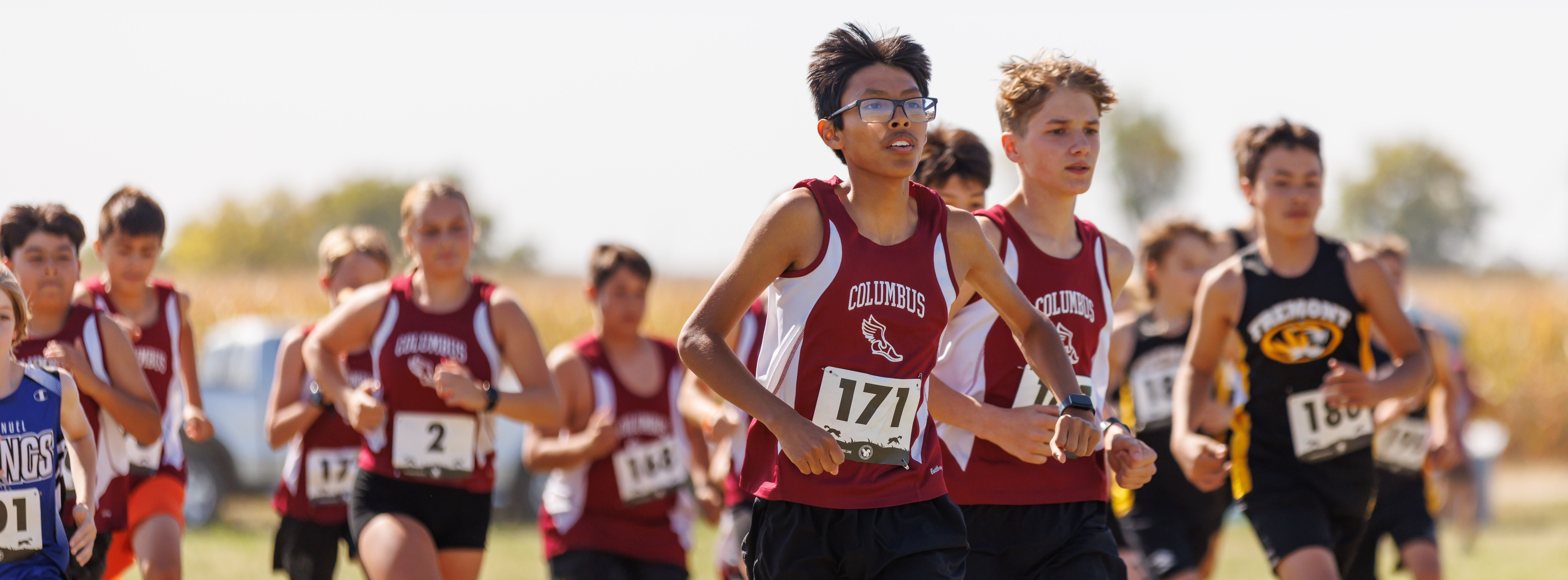 A Columbus Middle School cross country runner leads a group of runners out off the starting line during the school's home meet.